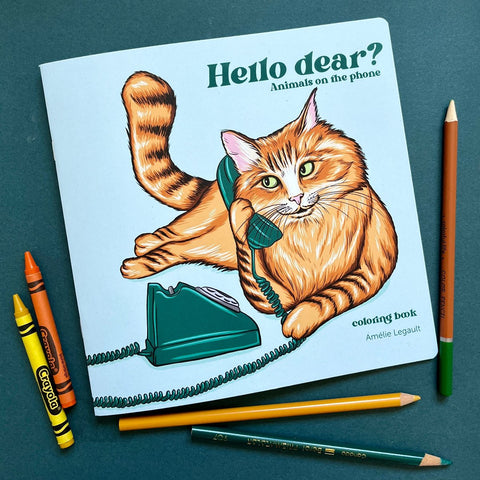 Coloring book on a table srrounded by crayons