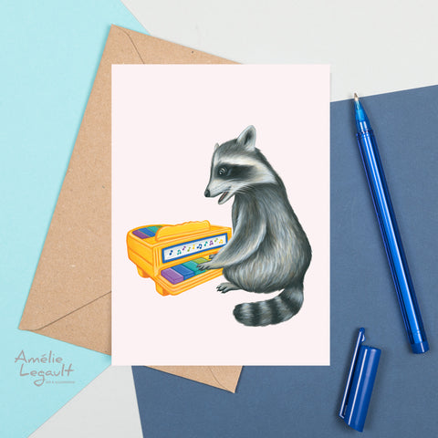 Baby Raccoon playing on vintage toy piano - Greeting Card