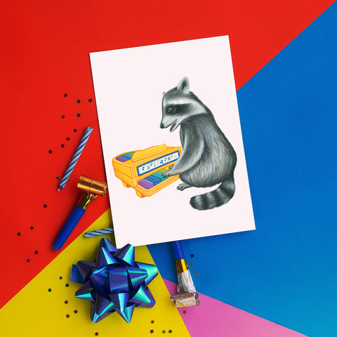 Baby Raccoon playing on vintage toy piano - Greeting Card